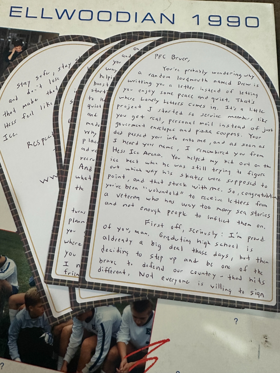 Handwritten letters from Lonely Letters laid out on an Ellwoodian yearbook